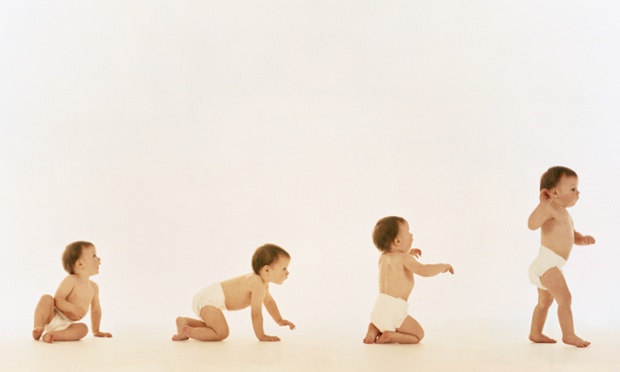 Composite of baby(12 months)in  disposable nappy taking first step